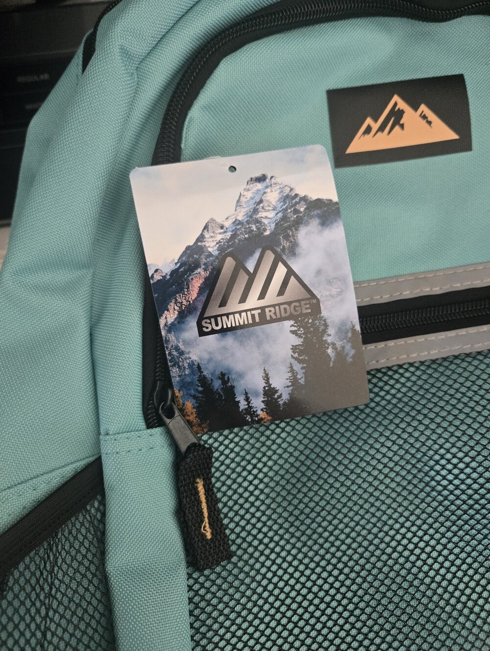 Summit Ridge blue backpack with reflective zip binding, rugged poly